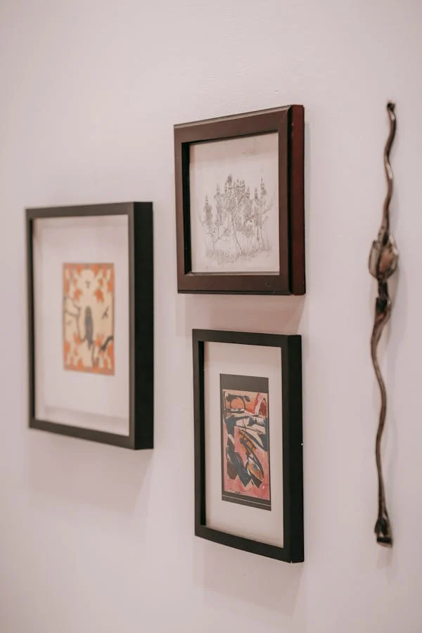 3 beautiful art pieces hanging on a wall