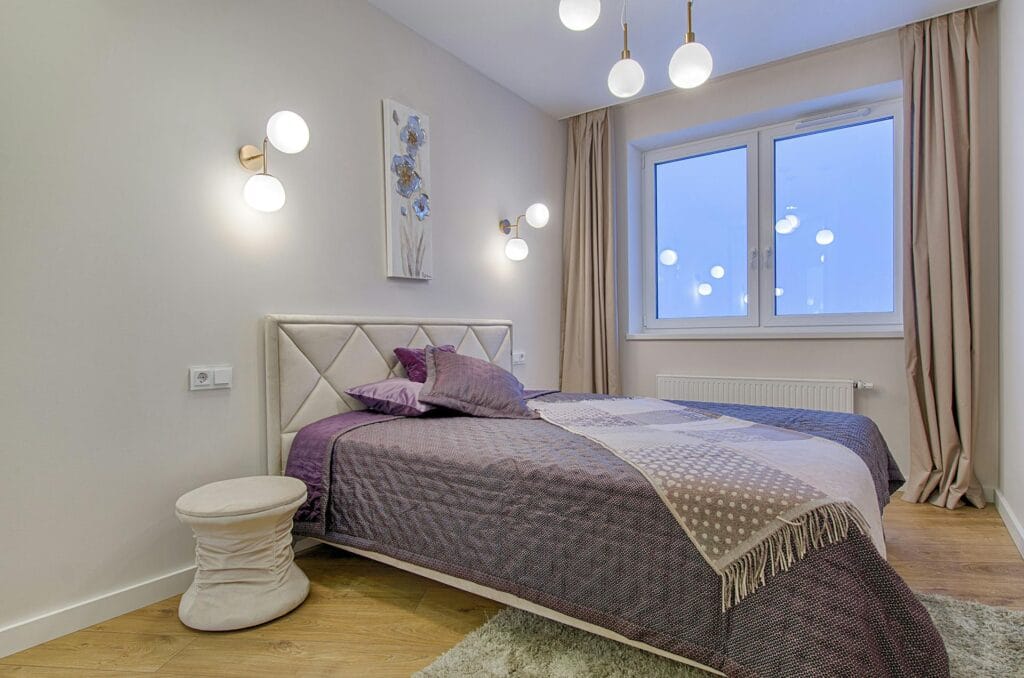 bedroom with good lighting and a beautiful headboard that goes brilliantly with the bed